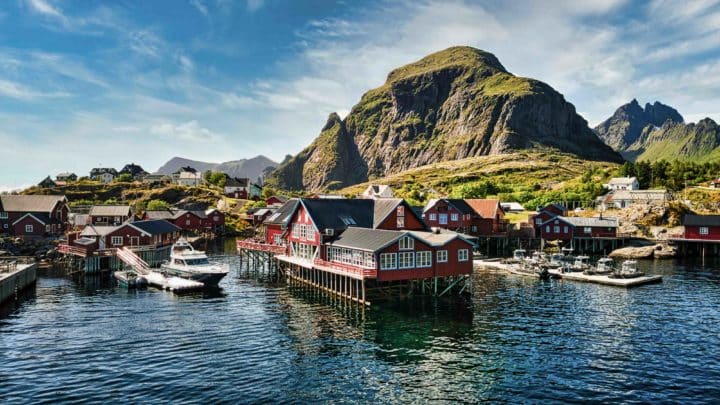 Red cabins by the sea with mountains and winter atmosphere, Å Rorbuer, Classic Norway Hotels.